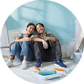 Man and woman sit on floor together smiling